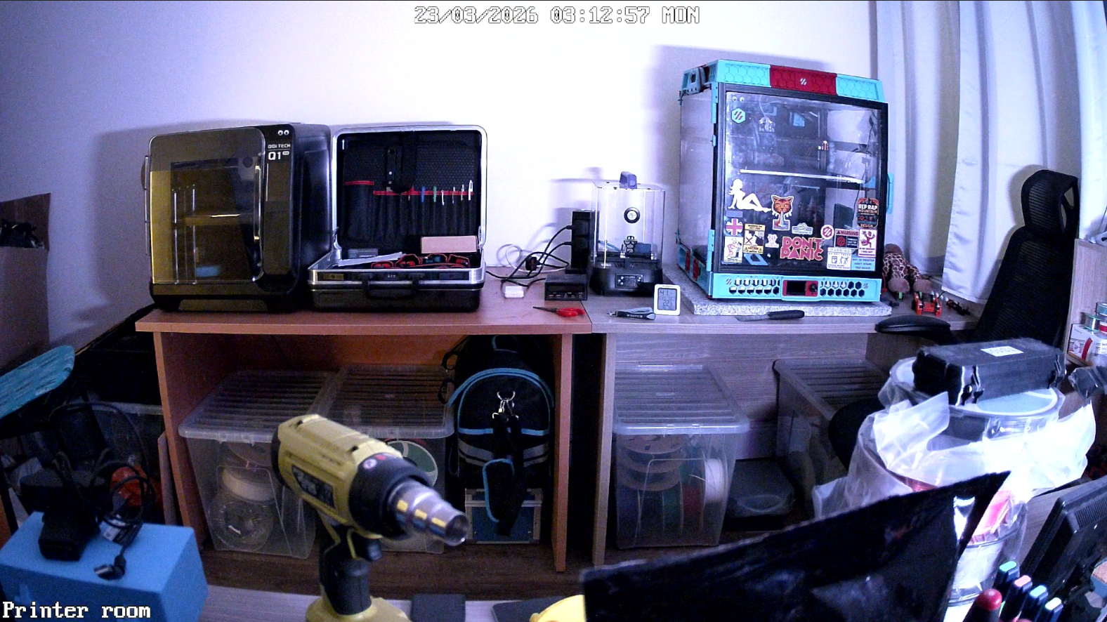 Printer room shelf with multiple 3D printers and filament storage