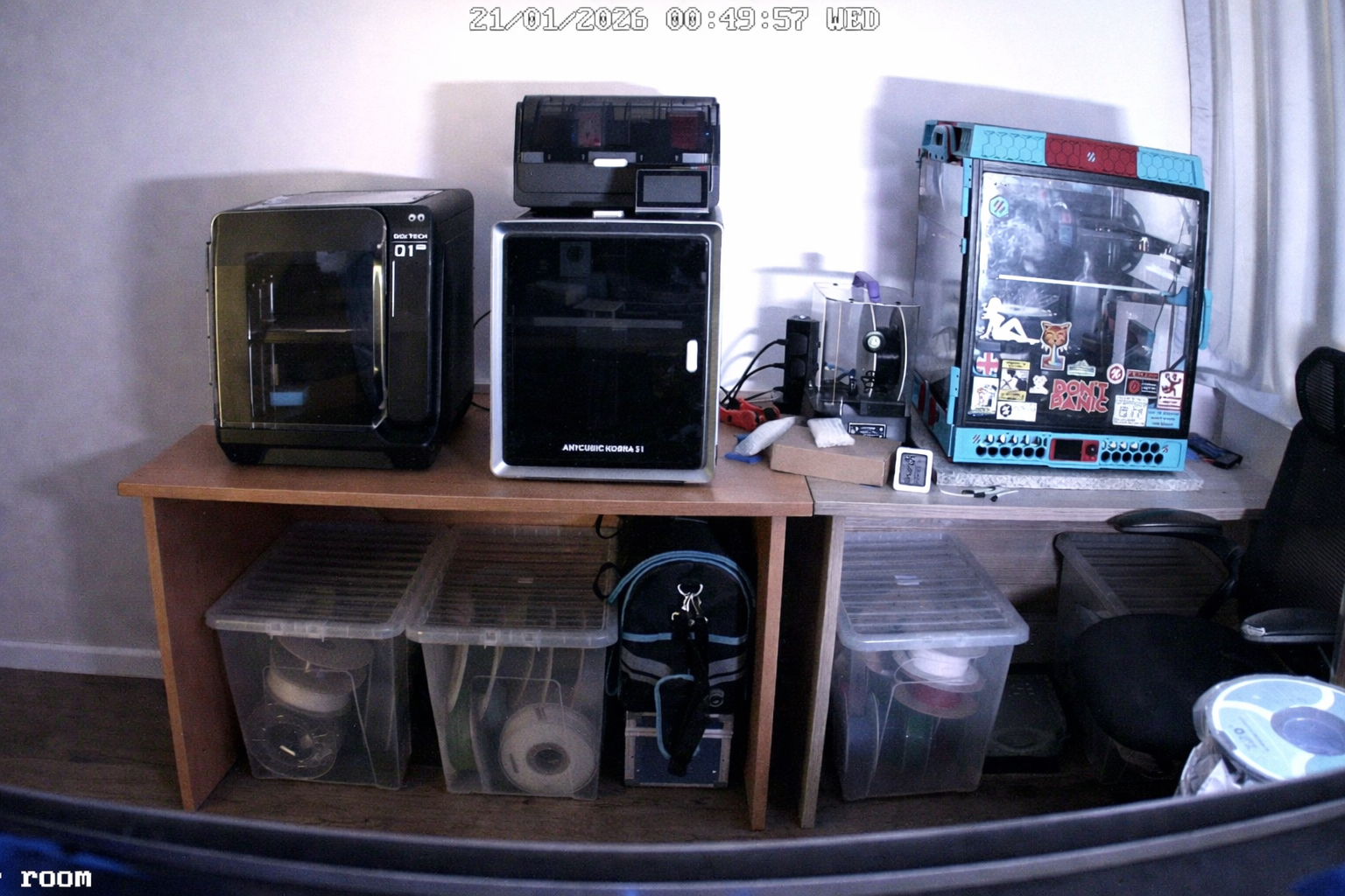 Printer room shelf with multiple 3D printers and filament storage